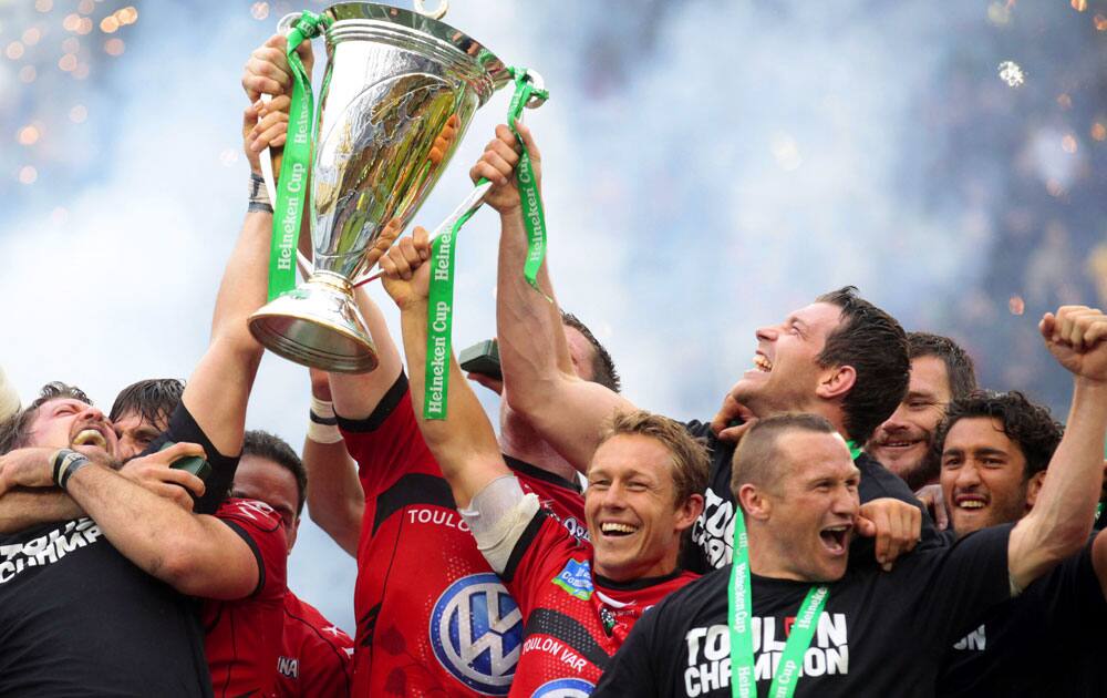 Jonny Wilkinson, center, holds up the trophy with teammates after Toulon are crowned European Cup Rugby champions after defeating Clermont Auvergne at the Aviva Stadium, Dublin, Ireland. 