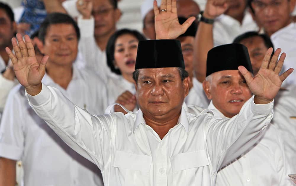 Indonesian presidential candidate Prabowo Subianto, center, and his running mate Hatta Rajasa, rear, greet supporters as they declare their candidacy in July`s presidential election, in Jakarta.