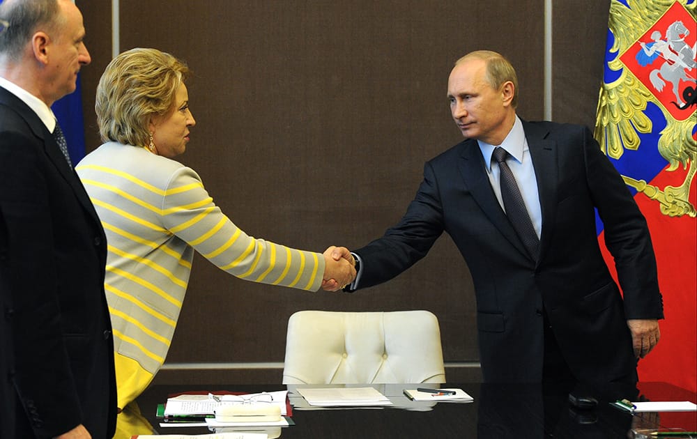 Russian President Vladimir Putin shakes hands with upper parliament chamber speaker Valentina Matviyenko prior to the Security Council meeting in the Russian Black Sea resort of Sochi.