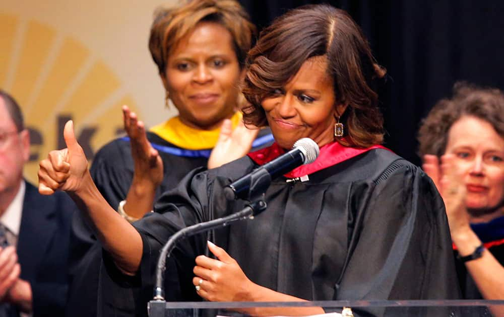 First lady Michelle Obama gives a thumbs up to students during Topeka Public Schools Senior Recognition Program in Topeka, Kan.