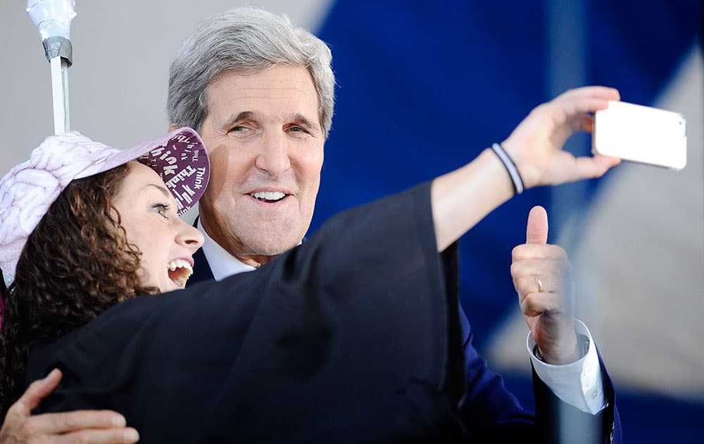 Secretary of State John Kerry, right poses for a selfie with Yale student Ariel Kirshenbaum during Class Day at Yale University, in New Haven, Conn.