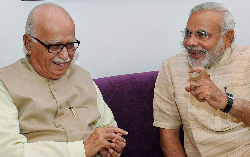 Bharatiya Janata Party leader and the next Prime Minister Narendra Modi with senior party leader L K Advani during their meeting in New Delhi.