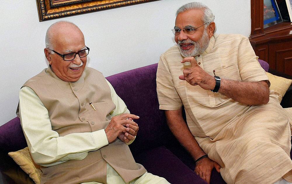 Bharatiya Janata Party leader and the next Prime Minister Narendra Modi with senior party leader L K Advani during their meeting in New Delhi.