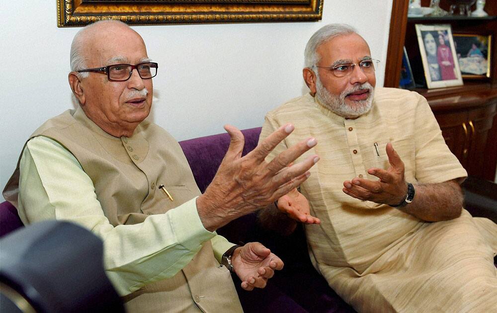 Bharatiya Janata Party leader and the next Prime Minister Narendra Modi with senior party leader L K Advani during their meeting in New Delhi.