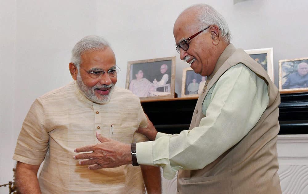 Bharatiya Janata Party leader and the next Prime Minister Narendra Modi with senior party leader L K Advani during their meeting in New Delhi.