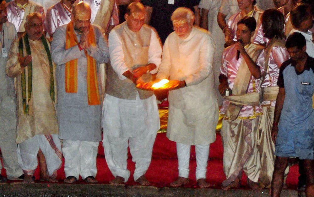 BJP leader and the next Prime Minister Narendra Modi with party President Rajnath Singh, party leader Amit Shah and others performing Ganga Aarti in Varanasi.