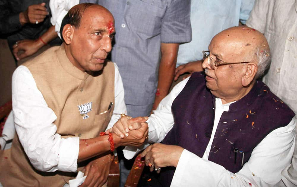 BJP national president Rajnath Singh with outgoing MP Lalji Tandon at party office in Lucknow on Friday. Singh paid a brief visit to the constituency from where he has emerged victorious to thank the electorate.