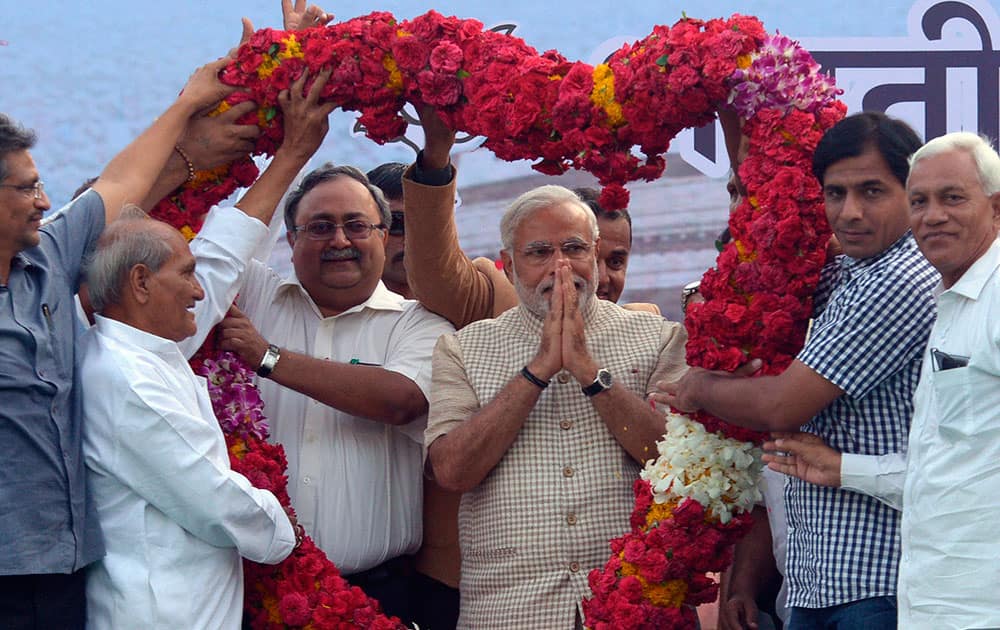 6:15 PM Bharatiya Janata Party (BJP) leader and India`s next prime minister Narendra Modi receives a giant floral garland from supporters after his landslide victory in Vadodara, in the western Indian state of Gujarat.