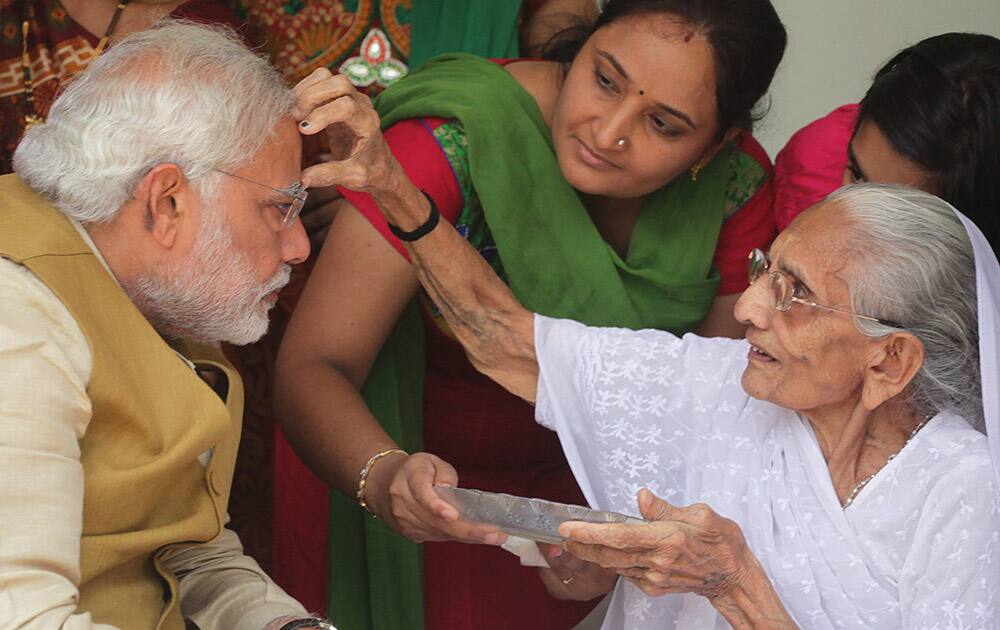 90-year-old Hiraben marks the forehead of her son and India`s next prime minister Narendra Modi with vermillion as a sign of blessing in Gandhinagar, Gujarat.