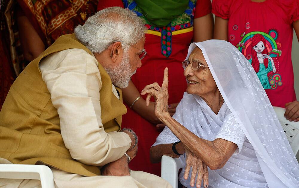 Narendra Modi listens to his 90-year-old mother Hiraben during a visit to seek her blessings after preliminary results showed his party winning by a landslide, in Gandhinagar, Gujarat.