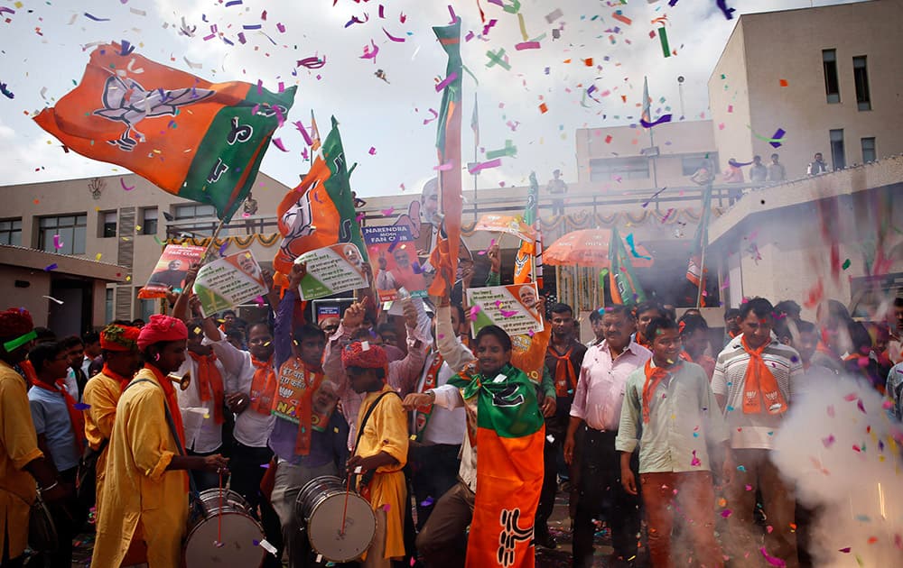 Bharatiya Janata Party (BJP) supporters celebrate outside the party office in Gandhinagar, in the western Indian state of Gujarat.