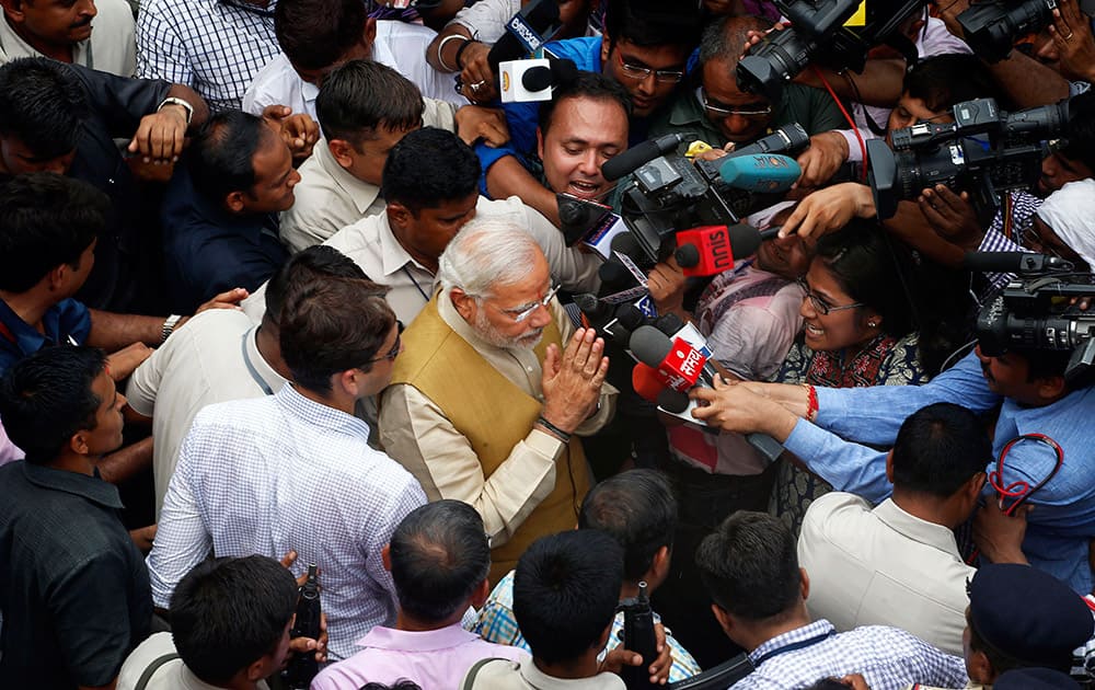 12:35 P.M.- Bharatiya Janata Party (BJP) leader and India`s next prime minister Narendra Modi greets the media as he leaves the residence of his 90-year-old mother in Gandhinagar, in the western Indian state of Gujarat.