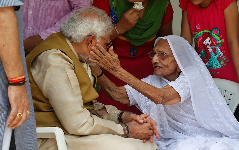 12:15 P.M.- Narendra Modi sits with his 90-year-old mother Hiraben during a visit to seek her blessings after preliminary results showed his party winning by a landslide, in Gandhinagar, in the western Indian state of Gujarat.