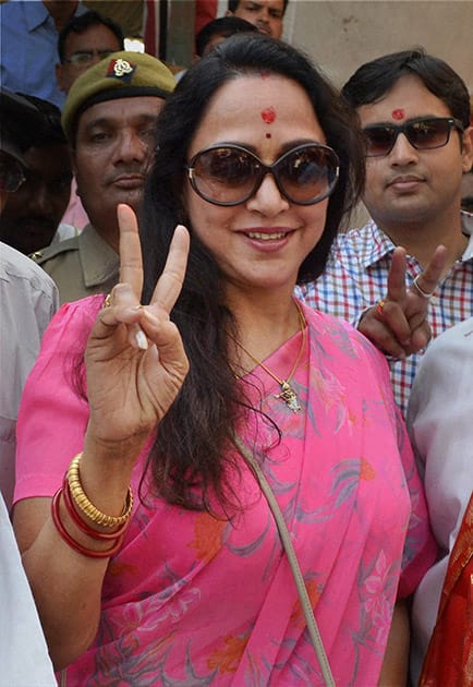 Bollywood actress and BJP candidate Hemamalini waves victory sign as she arrives at a counting station in Mathura.