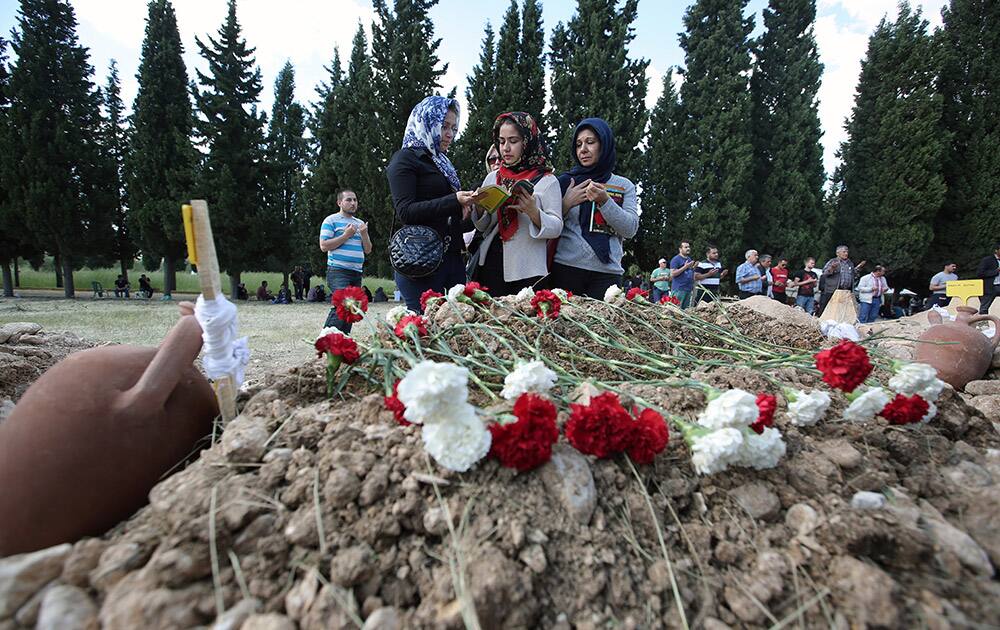 Family members pray after the burial of a mine accident victim in Soma, Turkey.