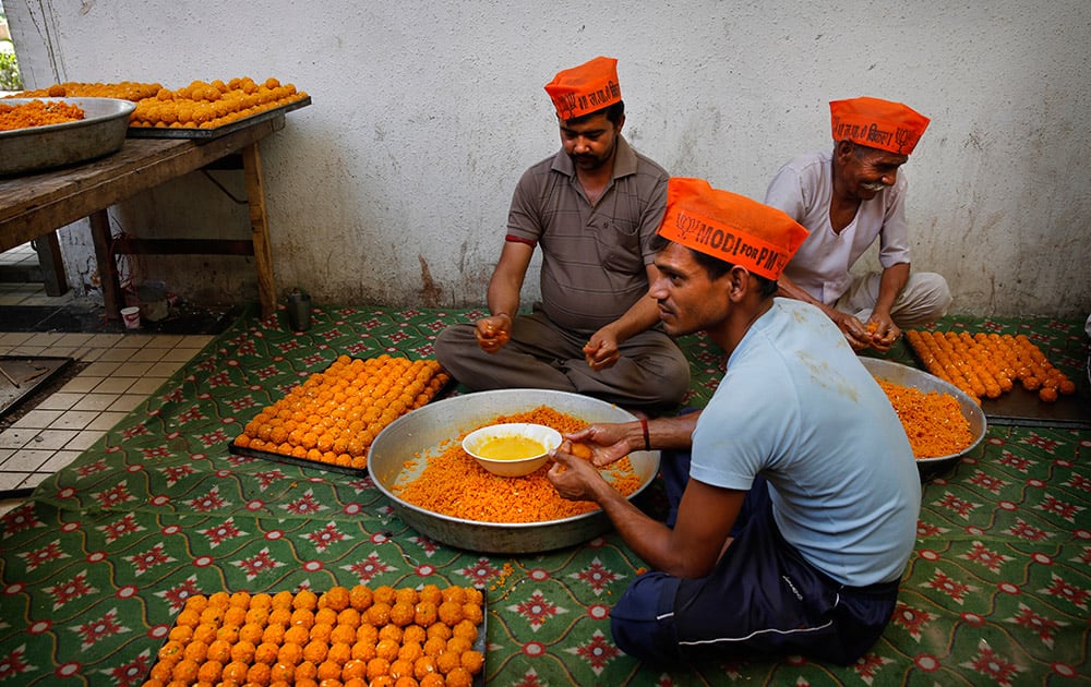 Workers prepare sweets anticipating election victory for the Bharatiya Janata Party (BJP) at the party’s headquarters, in New Delhi.