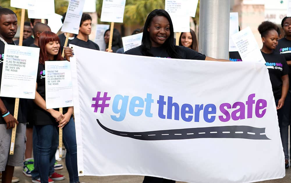 Student leader Crichanni Watson and other students at Royal Palm Beach High School in Royal Palm Beach, Fla. hoist the #GetThereSafe flag during a ceremony in support of The Allstate Foundation’s #GetThereSafe teen safe driving program.