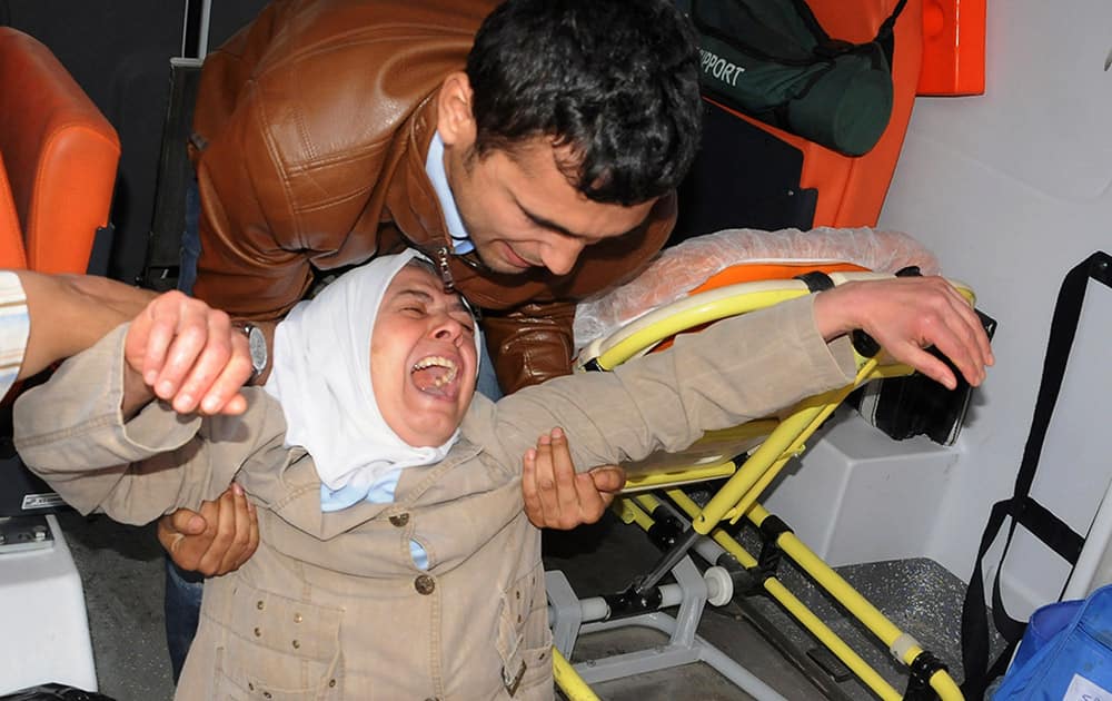 A woman reacts after she have seen the dead body of a relative miner outside the mine in Soma, western Turkey.