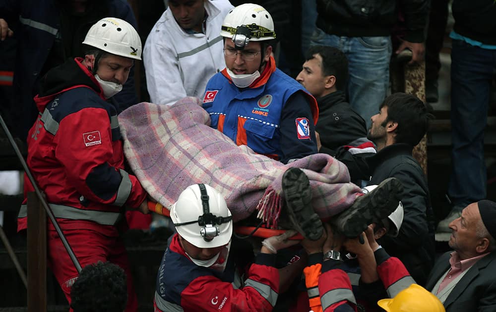 Rescue workers carry the dead body of a miner from the mine in Soma, western Turkey.