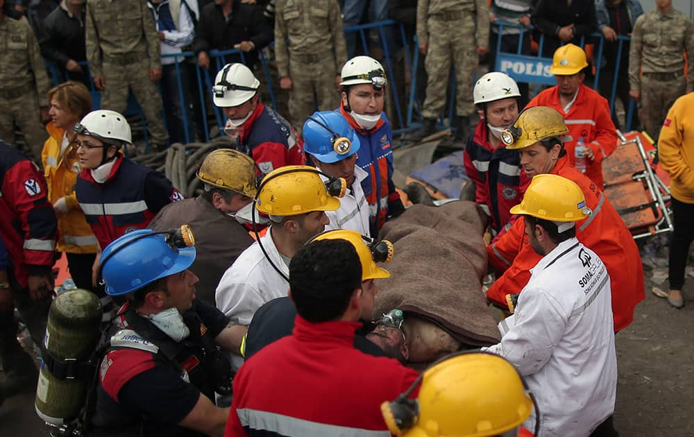 Rescue workers carry a rescued miner from the mine in Soma, western Turkey. Rescuers desperately raced against time to reach more than 200 miners trapped underground Wednesday after an explosion and fire at a coal mine in western Turkey killed at least 205 workers, authorities said.