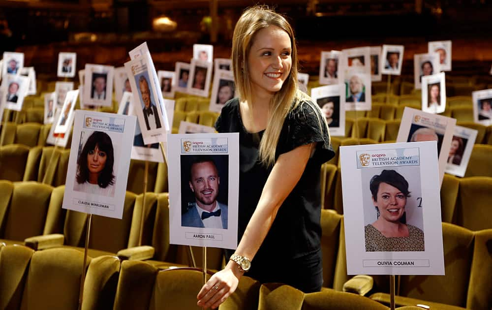 A picture of American actor Aaron Paul is positioned by Faye Nixon as the seating plan is arranged during a rehearsal ahead of the British Academy Television Awards taking place at the Theatre Royal in London.