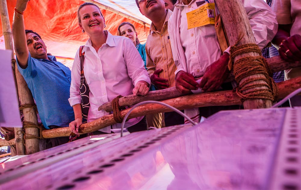 11 May 2014 - Lise grande, UN Resident Coordinator and UNDP Resident Representative in India understanding the use of an electronic voting machines by a election officer at an Elections Commission facility in Varanasi, India. [Photo: UNDP India]