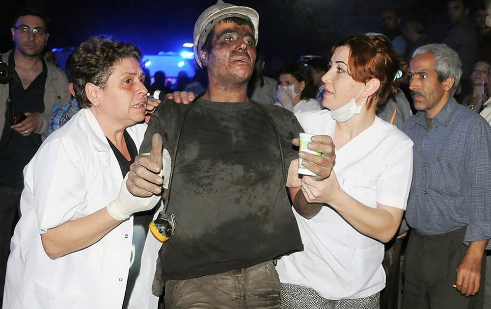 Medics help a rescued miner after an explosion and fire at a coal mine killed at least 17 miners and left up to 300 workers trapped underground, in Soma, in western Turkey.