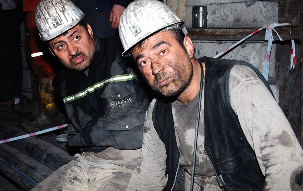 Two miners look around after being rescued hours after an explosion and fire at a coal mine killed at least 17 miners and left up to 300 workers trapped underground, in Soma, in western Turkey.