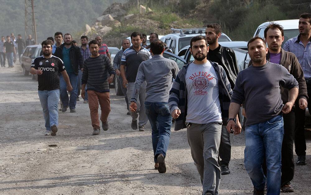 Workers and relatives arrive after an explosion and fire at a coal mine in Soma, in western Turkey.