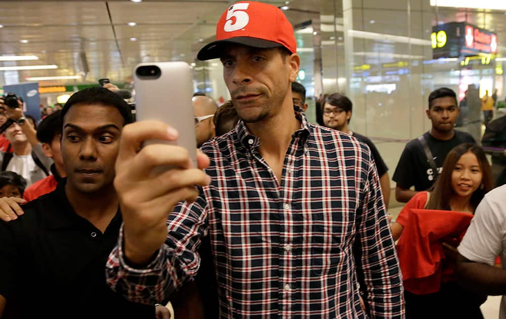 Manchester United`s Rio Ferdinand takes a `selfie` upon arrival at the Changi International Airport in Singapore. 