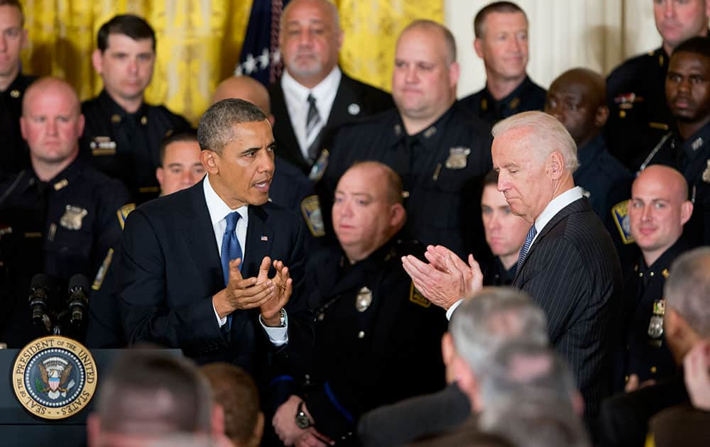 President Barack Obama and Vice President Joe Biden applaud a during a ceremony honoring the 2014 National Association of Police Organizations (NAPO) TOP COPS recipients in the East Room of the White House in Washington.