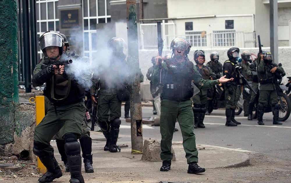 Bolivarian National Guards fire teargas at anti-government demonstrators demanding the release of arrested students in Caracas, Venezuela.