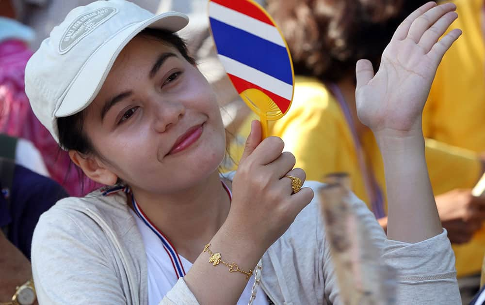 An anti-government protester cheers to a speech during a rally outside the Parliament in Bangkok, Thailand.