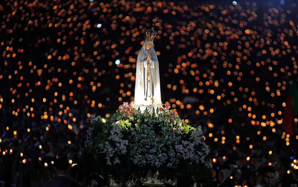 A statue of Our Lady of Fatima is carried during a candle light vigil at the Fatima Sanctuary, in Fatima, Portugal. Every year on May 12 and 13 thousands of Catholic pilgrims arrive to Fatima Sanctuary to attend Masses and pray in honor of the Virgin Mary, where it is believed she was witnessed by three shepherd children in 1917. 