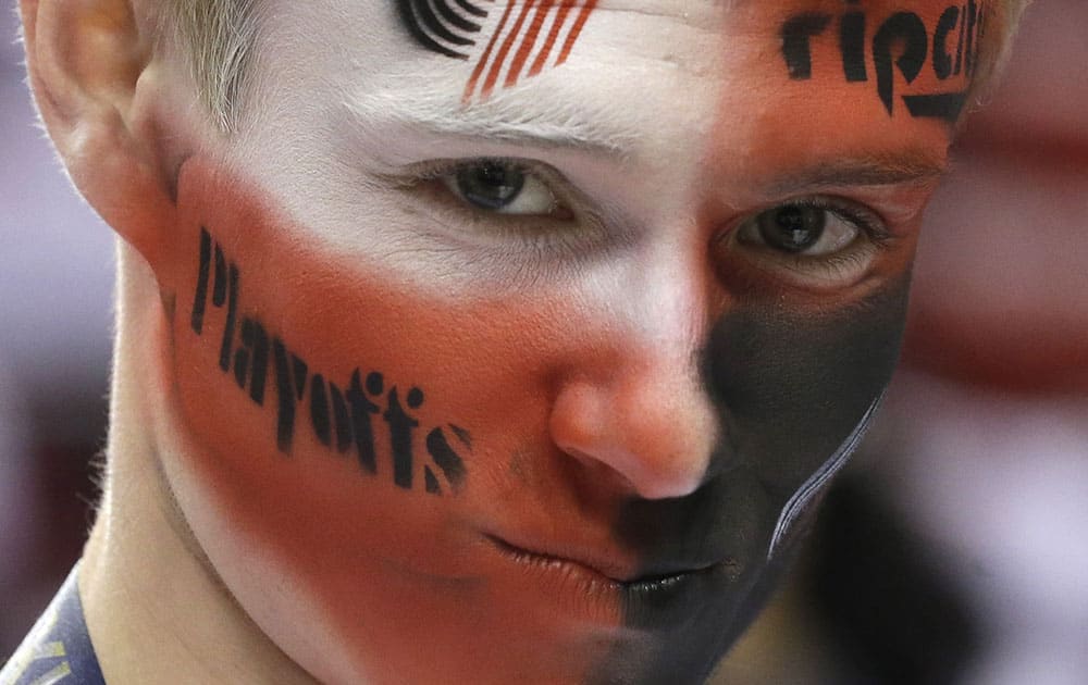 Portland Trail Blazers fan Jacob Weis watches practice before Game 4 of a Western Conference semifinal NBA basketball playoff series against the San Antonio Spurs in Portland, Ore. 