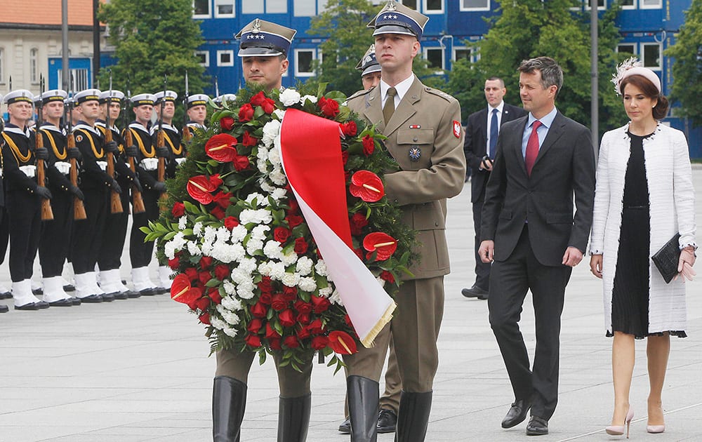 Denmark`s Crown Prince Frederik and Crown Princess Mary follow soldiers during the wreath laying ceremony at the Tomb of the Unknown Soldier in Warsaw, Poland.