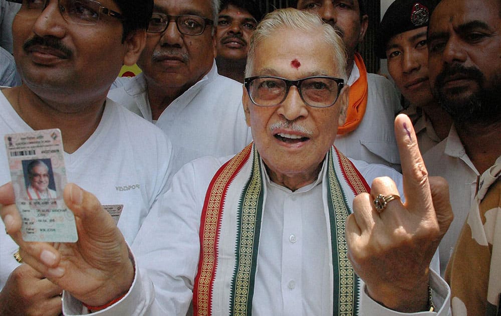 Senior BJP Leader M M Joshi shows his inked finger after casting his vote for the last phase of Lok Sabha election,in Varanasi.