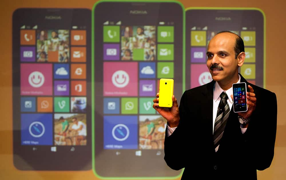 Managing Director Nokia India P. Balaji displays Lumia 630 mobile phones during its launch in New Delhi.