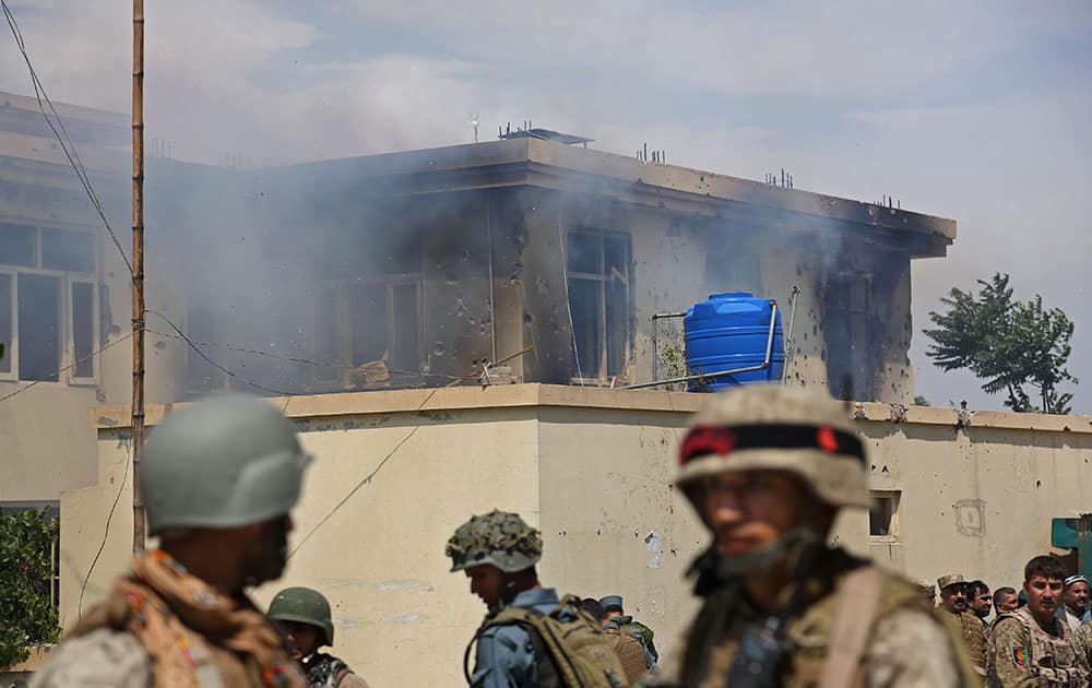 Smoke billows after Taliban fighters stormed a government building in Jalalabad, east of Kabul, Afghanistan.