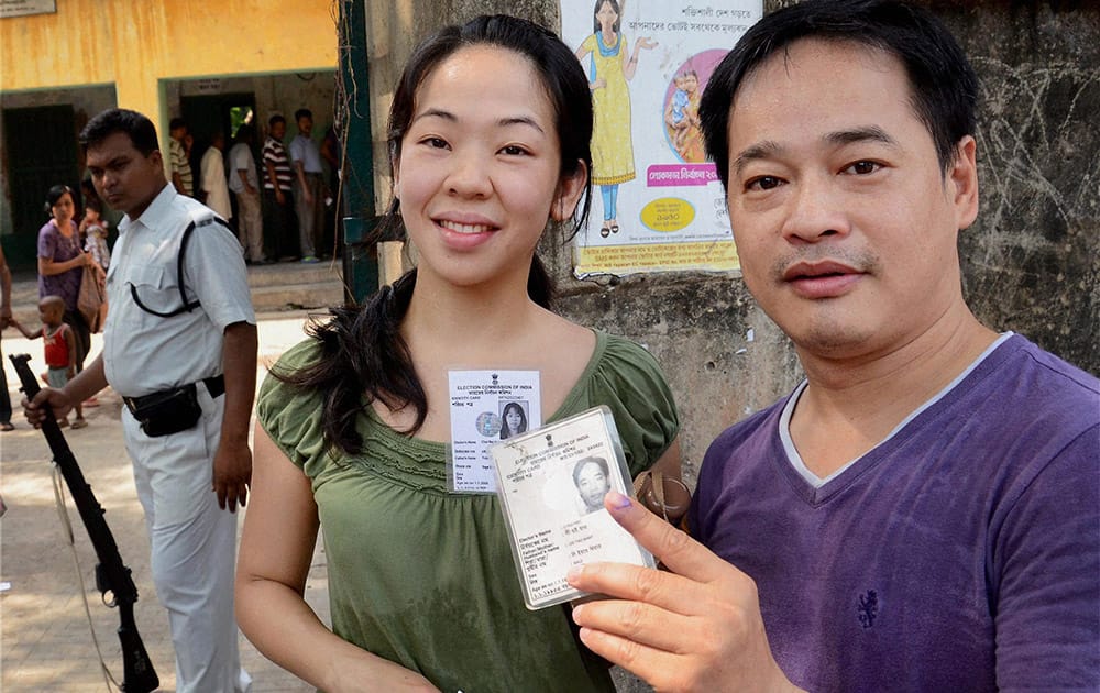 People showing their voter ID cards outside a polling booth at Chinatown in Kolkata during last phase of Lok Sabha polls.