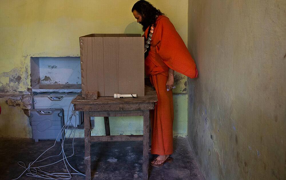 A Sadhu casts his vote at a polling station in Varanasi, Uttar Pradesh.