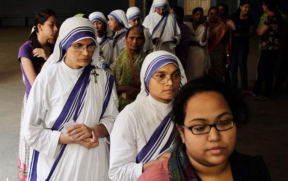 Nuns of the Missionaries of Charity, the order founded by late Mother Teresa, wait in a queue to cast their votes at a polling station in Kolkata.