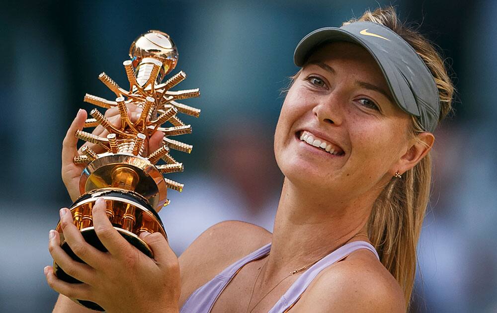 Maria Sharapova from Russia celebrates her victory holding her trophy during a Madrid Open tennis tournament final match against Simona Halep from Romania.