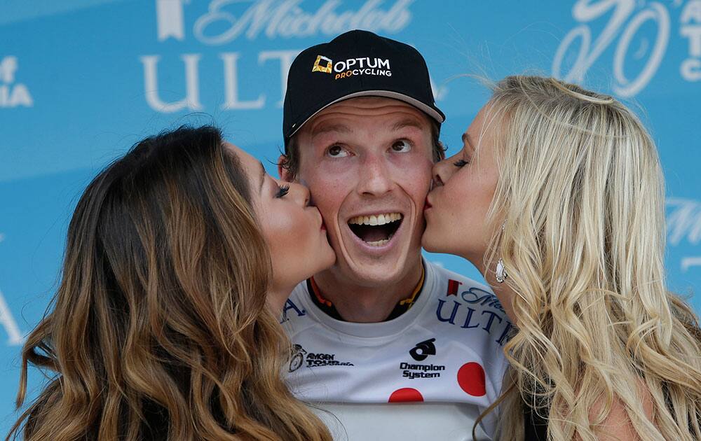 Will Routley, of Canada, a rider fir Optum Pro Cycling, smiles as he receives kisses after winning the King of the Mountain Jersey of Stage I of the Tour of California cycling race, in Sacramento, Calif.