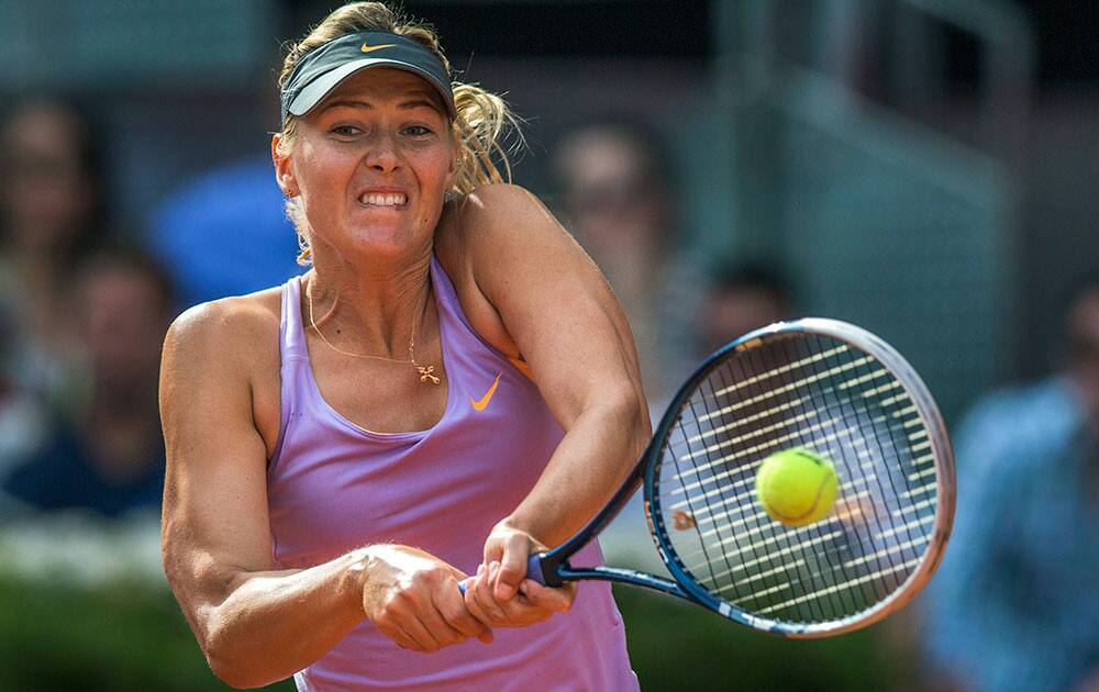 Maria Sharapova from Russia returns the ball during her Madrid Open tennis tournament final match against Simona Halep from Romania.