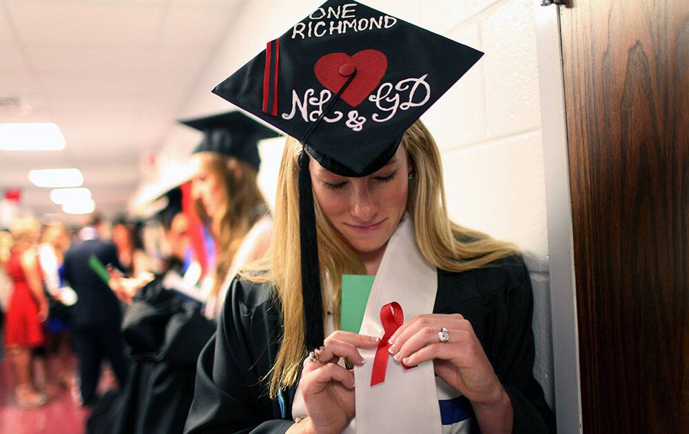 Laura Jordan wears a red ribbon with her hat decorated with initials of Natalie Lewis and Ginny Doyle before the University of Richmond`s Commencement Ceremony in Richmond, Va. 