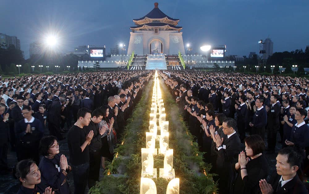 Taiwanese people pray together during the Taiwan National Buddha`s Birthday celebration in front of the Chiang Kai-shek Memorial Hall in Taipei, Taiwan.