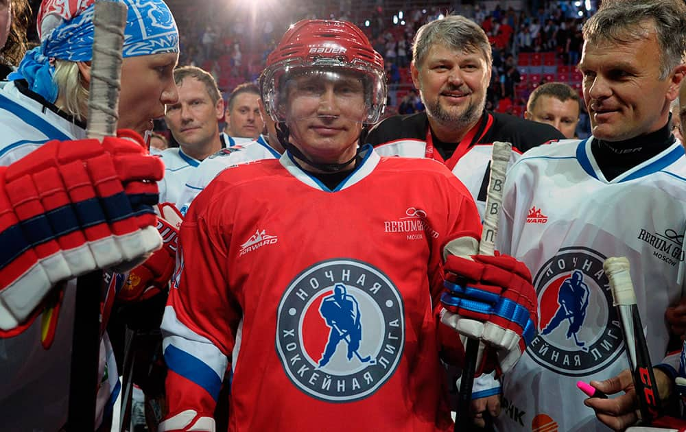 Russian President Vladimir Putin, center, poses after an ice hockey match between Russian amateur players and ice hockey stars at a festival of Russia`s amateur hockey organized by the Night Hockey League in the Bolshoy arena in the Olympic Park in the Black Sea resort of Sochi, Russia.