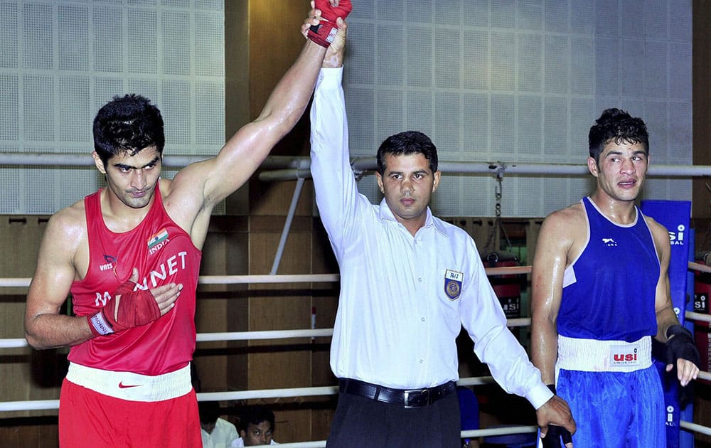 Boxer Vijender Singh is declared winner after a fight during selection trials for the core group probables for Commonwealth Games and Asian Games 2014, in Patiala.