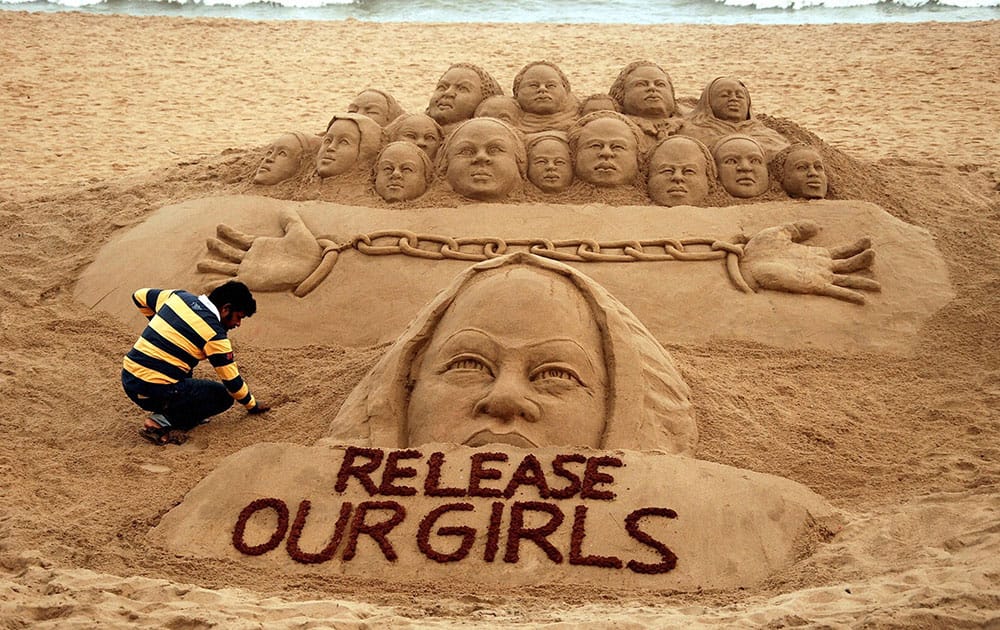 Sand artist Sudarsan Pattnaik creates a sand sculpture on release of the kidnapped school girls in Nigeria, at Puri beach of Odisha.